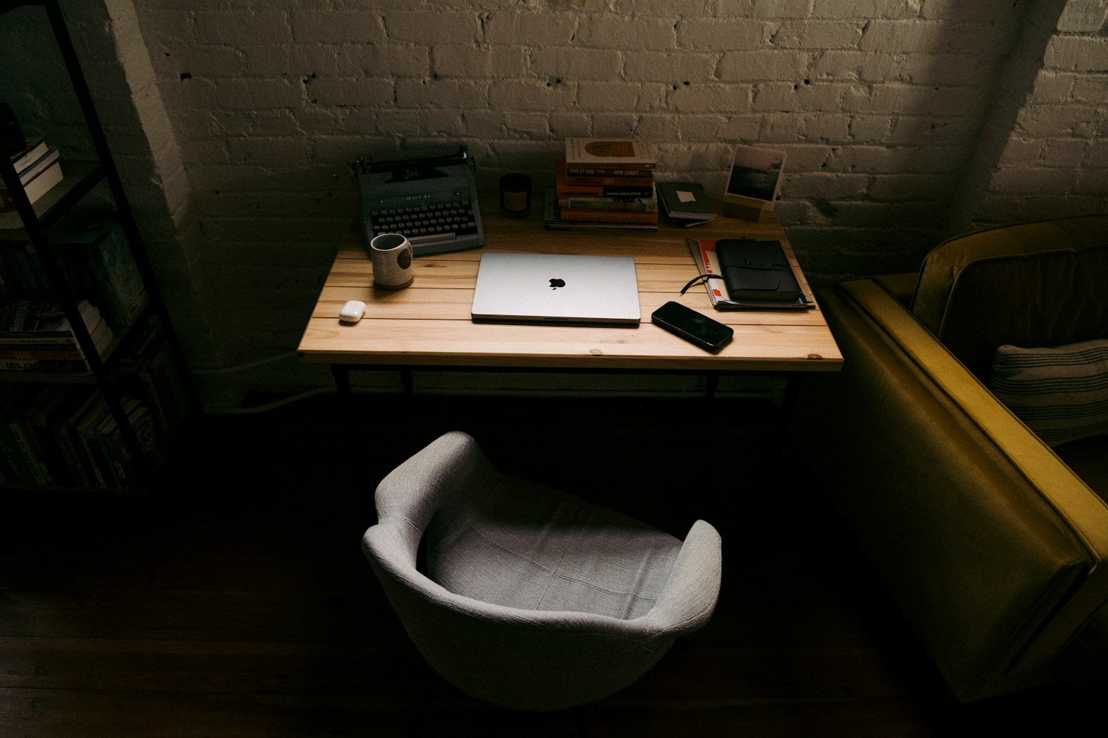 a laptop computer sitting on top of a wooden desk